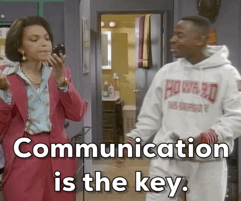 A GIF of one person kissing another, with the caption 'communication is the key'